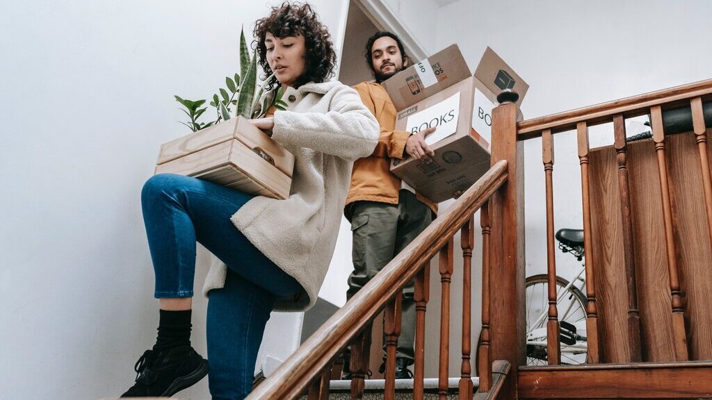 Diamond Cleaning move in / move out cleaning service in Edmonton, AB. Image of people going down the stairs lifting boxes